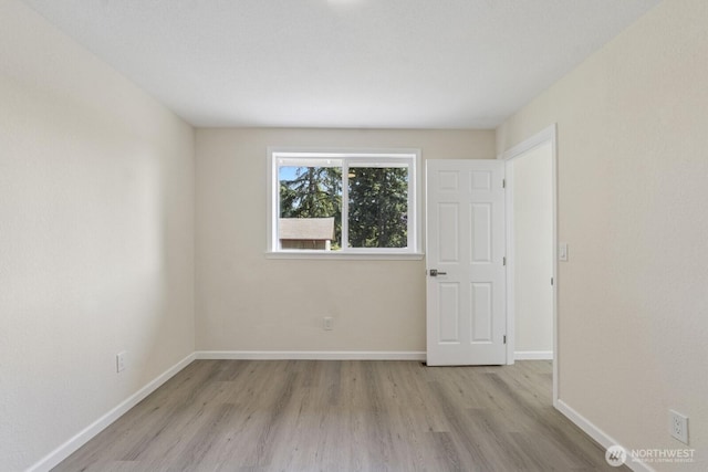 16828 Ambaum Blvd S, Burien, WA 98148 - empty room featuring wood finished floors and baseboards