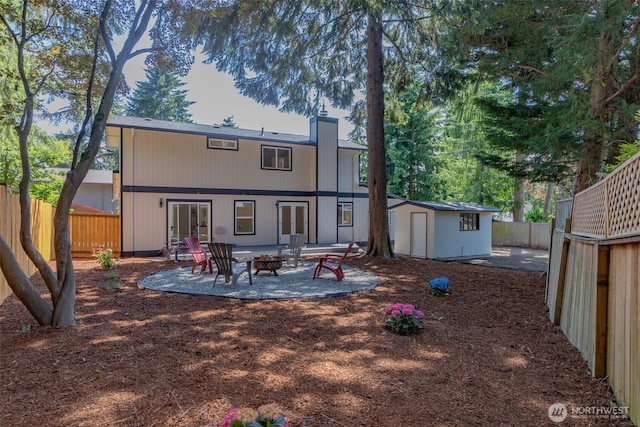 16828 Ambaum Blvd S, Burien, WA 98148 - back of property with an outdoor fire pit, french doors, a patio area, a fenced backyard, and a storage shed