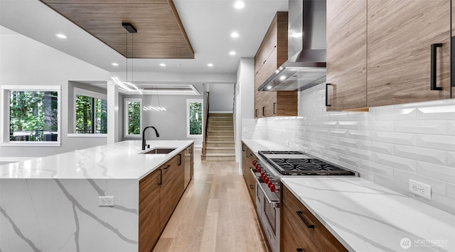 1542 213th Ct NE, Sammamish, WA 98074 - kitchen featuring wall chimney range hood, a sink, modern cabinets, light wood-style floors, and recessed lighting