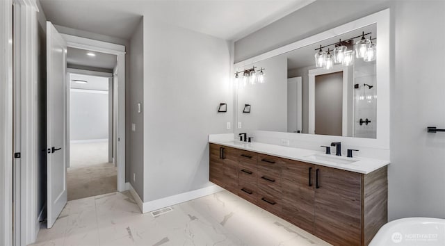 1542 213th Ct NE, Sammamish, WA 98074 - bathroom featuring marble look tile flooring, double vanity, baseboards, a freestanding bath, and recessed lighting