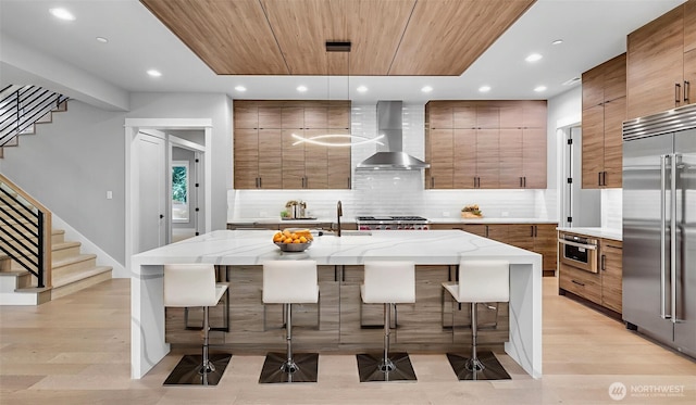 1542 213th Ct NE, Sammamish, WA 98074 - kitchen with wall chimney exhaust hood, built in fridge, modern cabinets, recessed lighting, and brown cabinetry