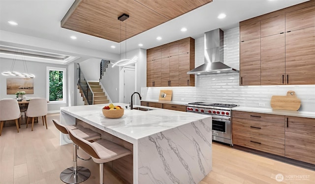 1542 213th Ct NE, Sammamish, WA 98074 - kitchen with luxury stove, wall chimney range hood, a sink, light wood-type flooring, and recessed lighting