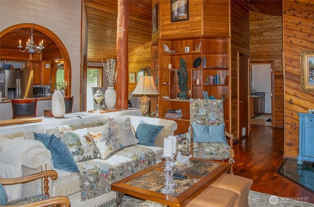 70 Cole Ave, Port Townsend, WA 98368 - living area featuring high vaulted ceiling, wood finished floors, wooden walls, a chandelier, and arched walkways