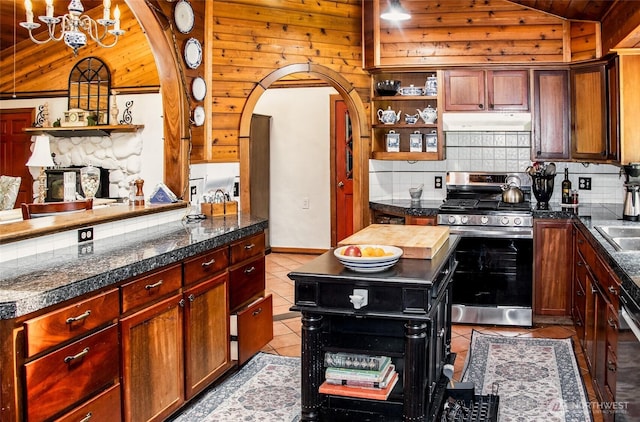70 Cole Ave, Port Townsend, WA 98368 - kitchen featuring gas stove, lofted ceiling, tile countertops, arched walkways, and backsplash
