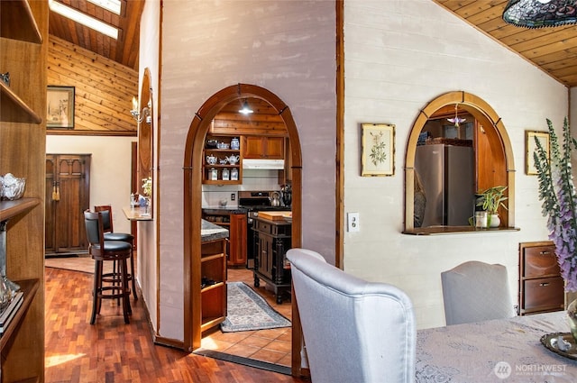 70 Cole Ave, Port Townsend, WA 98368 - dining area with wooden ceiling, arched walkways, dark wood-style flooring, high vaulted ceiling, and wooden walls