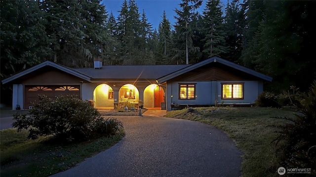 70 Cole Ave, Port Townsend, WA 98368 - ranch-style house with curved driveway, a garage, and stucco siding