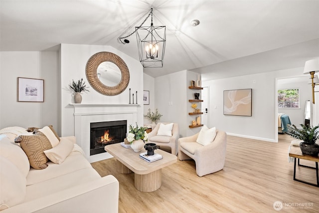 23311 Cedar Way Unit P201, Mountlake Terrace, WA 98043 - living area featuring a chandelier, wood finished floors, lofted ceiling, a tile fireplace, and baseboards