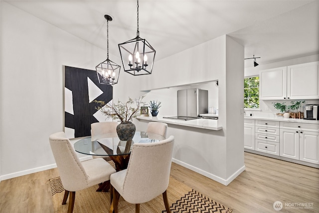 23311 Cedar Way Unit P201, Mountlake Terrace, WA 98043 - dining area with a chandelier, baseboards, and light wood-style flooring