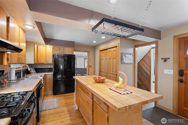 1010 Tacoma Ave, Port Orchard, WA 98366 - kitchen featuring black appliances, wood counters, light wood finished floors, a sink, and a kitchen island
