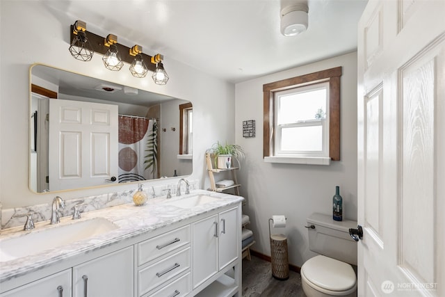 1010 Tacoma Ave, Port Orchard, WA 98366 - full bath with toilet, double vanity, baseboards, and wood finished floors