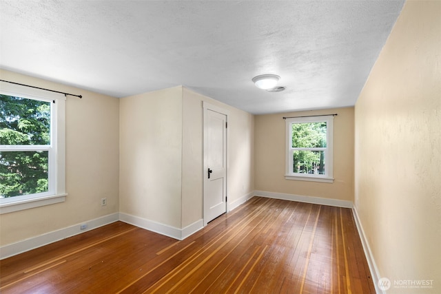 1010 Tacoma Ave, Port Orchard, WA 98366 - unfurnished bedroom featuring hardwood / wood-style floors, baseboards, and a textured ceiling
