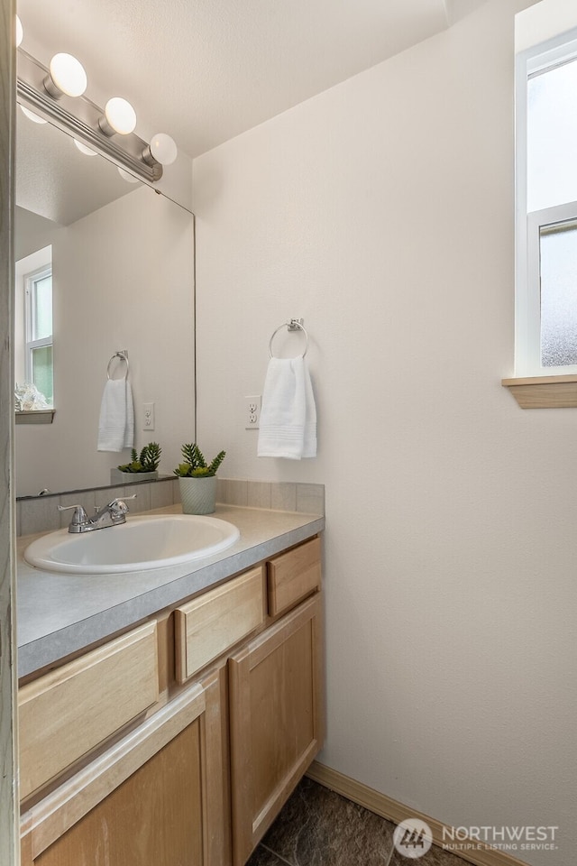 10049 17th Ave SW, Seattle, WA 98146 - bathroom featuring vanity, healthy amount of natural light, and baseboards