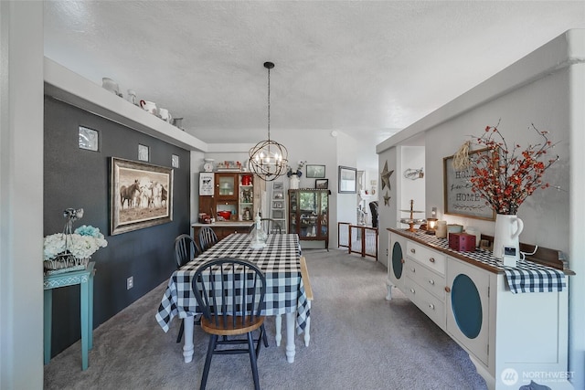 10419 Sandridge Rd, Long Beach, WA 98631 - dining room with carpet floors, a chandelier, and a textured ceiling
