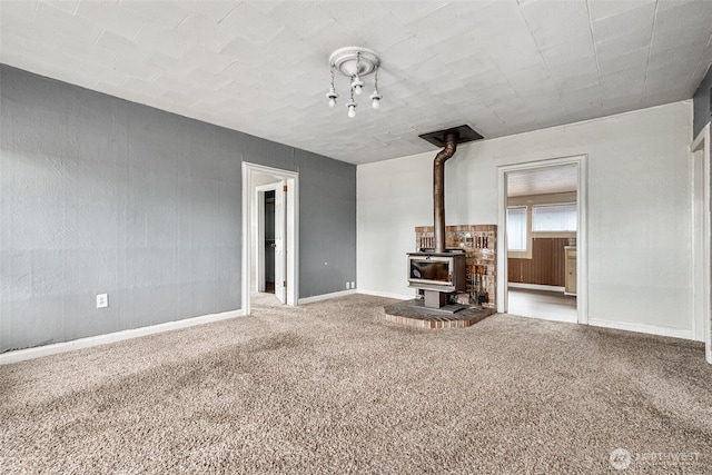 1863 Loraine St, Enumclaw, WA 98022 - unfurnished living room with a wood stove, carpet floors, and baseboards