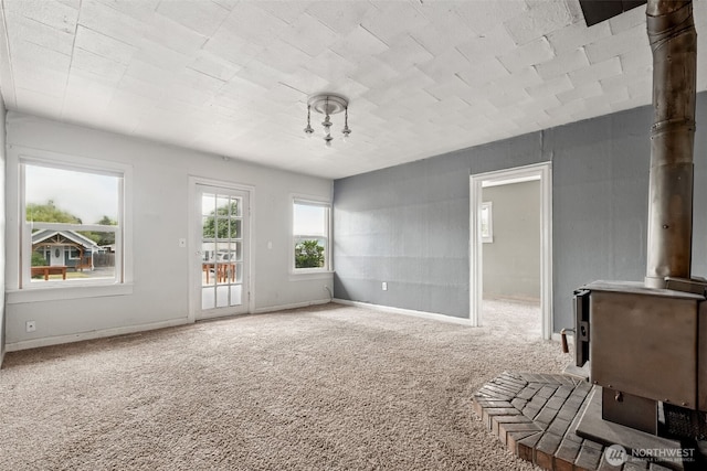 1863 Loraine St, Enumclaw, WA 98022 - carpeted spare room featuring a wood stove and baseboards