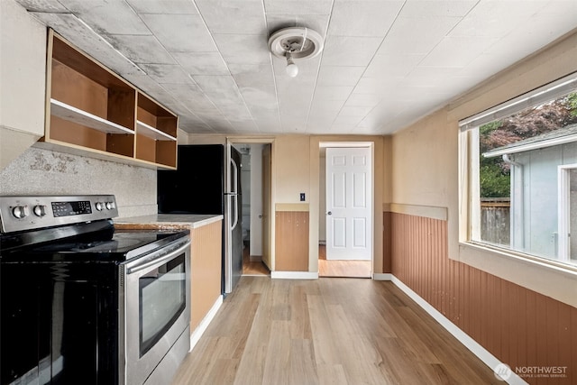 1863 Loraine St, Enumclaw, WA 98022 - kitchen with stainless steel electric range, light wood-type flooring, open shelves, a wainscoted wall, and light countertops