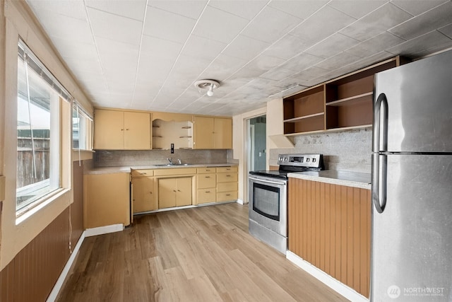1863 Loraine St, Enumclaw, WA 98022 - kitchen with stainless steel appliances, open shelves, a sink, light wood-style flooring, and backsplash