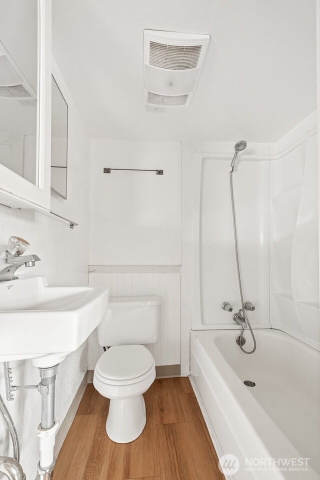 1863 Loraine St, Enumclaw, WA 98022 - bathroom with wood finished floors, toilet, shower / tub combination, and wainscoting