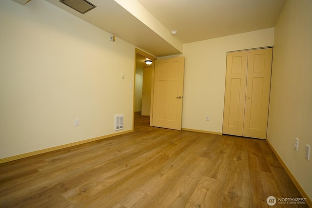 1031 N State St Unit 402, Bellingham, WA 98226 - unfurnished bedroom with wood finished floors and baseboards