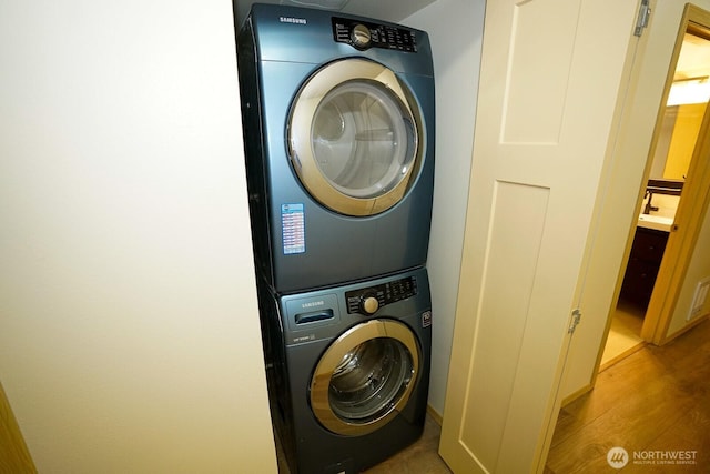 1031 N State St Unit 402, Bellingham, WA 98226 - laundry area with stacked washing machine and dryer and light wood finished floors