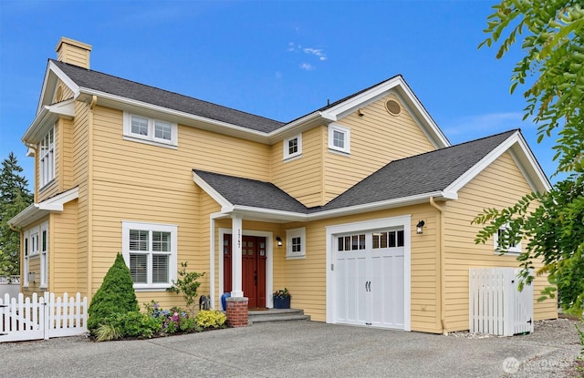1747 Parade Grounds Ave NE, Bainbridge Island, WA 98110 - traditional-style home with an attached garage, a chimney, asphalt driveway, and roof with shingles