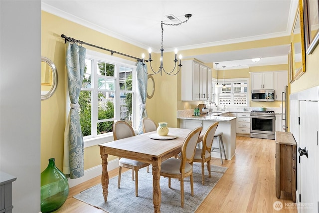 1747 Parade Grounds Ave NE, Bainbridge Island, WA 98110 - dining area featuring light wood-style floors, crown molding, and a chandelier