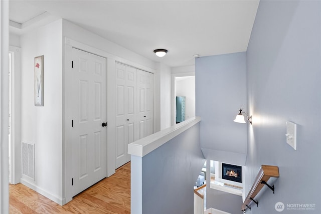 1747 Parade Grounds Ave NE, Bainbridge Island, WA 98110 - hall featuring an upstairs landing and light wood-type flooring
