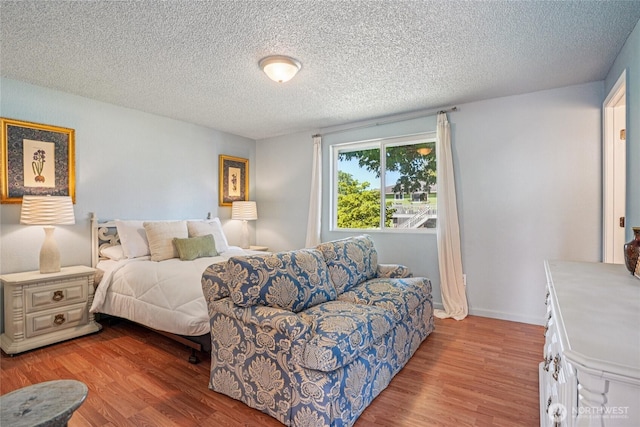 29103 46th Pl S, Auburn, WA 98001 - bedroom featuring wood finished floors, a textured ceiling, and baseboards