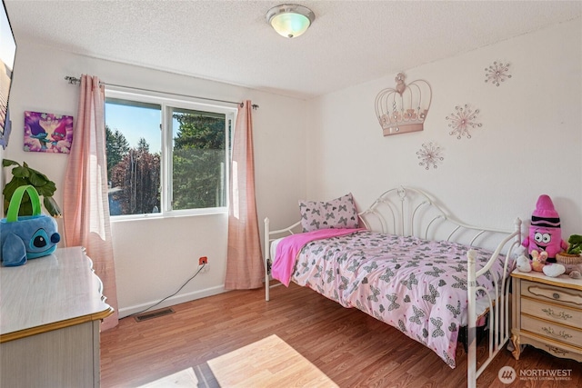 29103 46th Pl S, Auburn, WA 98001 - bedroom with wood finished floors, a textured ceiling, and baseboards