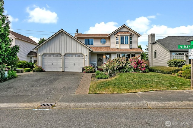 1102 SW 348th Pl, Federal Way, WA 98023 - traditional-style home with an attached garage, a front lawn, asphalt driveway, and board and batten siding