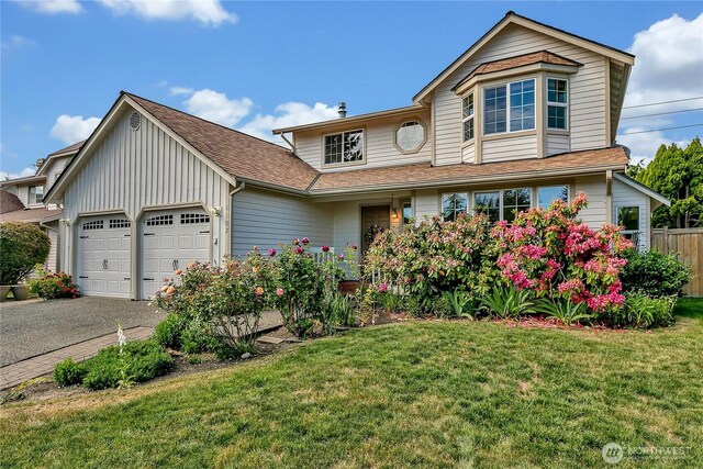 1102 SW 348th Pl, Federal Way, WA 98023 - traditional-style home featuring a garage, asphalt driveway, board and batten siding, and roof with shingles