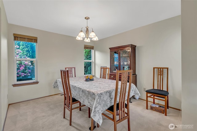 1102 SW 348th Pl, Federal Way, WA 98023 - dining space featuring a chandelier, light carpet, and baseboards