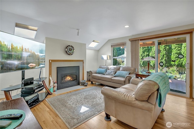 1102 SW 348th Pl, Federal Way, WA 98023 - living room with a tiled fireplace, wood finished floors, vaulted ceiling, and recessed lighting