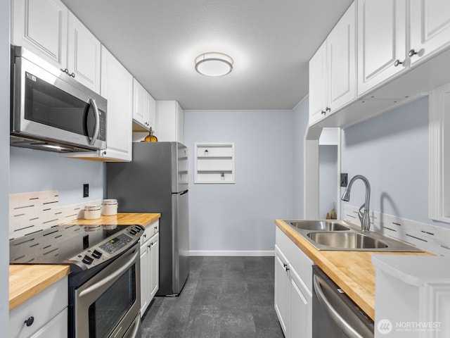 18210 15th Ave NE Unit 101, Shoreline, WA 98155 - kitchen featuring appliances with stainless steel finishes, butcher block countertops, baseboards, and white cabinetry