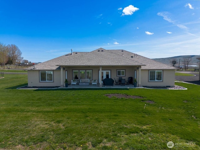 26602 N Rothrock Rd, Prosser, WA 99350 - rear view of house with stucco siding, a patio, a yard, and an outdoor living space