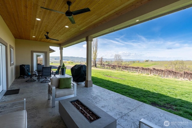26602 N Rothrock Rd, Prosser, WA 99350 - view of patio / terrace featuring an outdoor fire pit, grilling area, a ceiling fan, outdoor dining space, and a view of rural / pastoral area