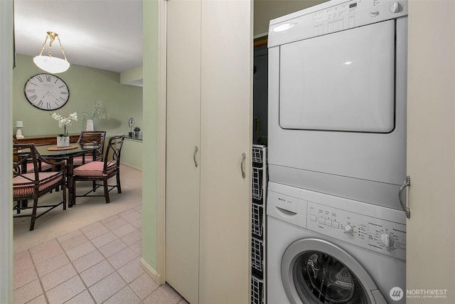 2253 Gilman Dr W Unit 207, Seattle, WA 98119 - laundry room with estacked washer and dryer, baseboards, and light carpet