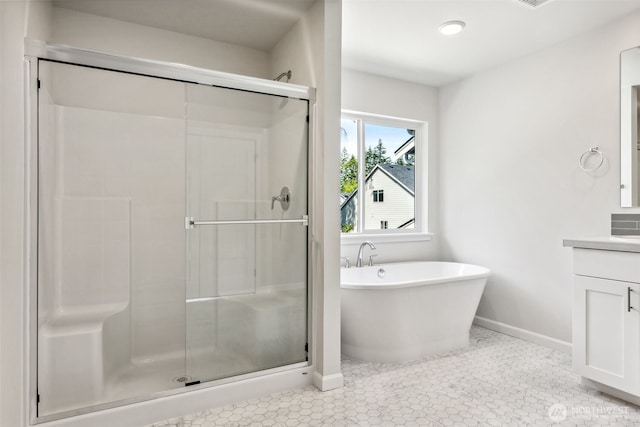 16617 8th Avenue Ct E Unit 9, Spanaway, WA 98387 - bathroom with vanity, a stall shower, a freestanding bath, and tile patterned flooring