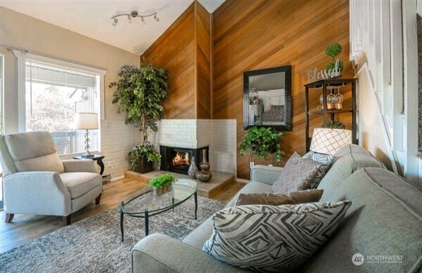 7530 Birch Bay Dr Unit 206, Blaine, WA 98230 - living area with a brick fireplace, wood finished floors, and wood walls