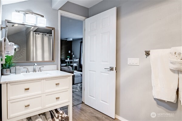 7530 Birch Bay Dr Unit 206, Blaine, WA 98230 - full bathroom with vanity, wood finished floors, and baseboards