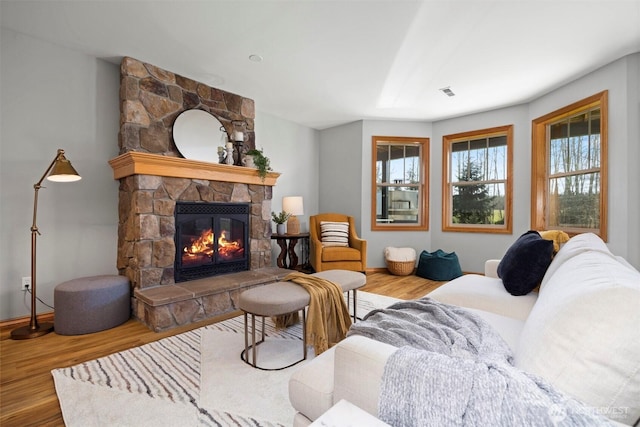 367 E Silverado Ct, Bellingham, WA 98226 - living room with wood finished floors, a stone fireplace, and baseboards