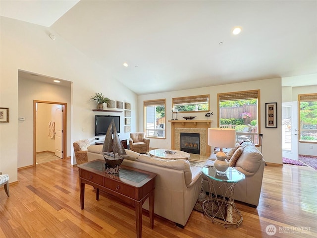 1427 N Aurora Ct, Port Angeles, WA 98363 - living area with a premium fireplace, light wood-type flooring, lofted ceiling, and recessed lighting