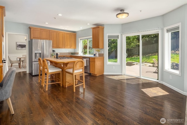 328 210th St SE, Bothell, WA 98021 - kitchen with stainless steel appliances, a kitchen island, dark wood-style floors, a kitchen bar, and recessed lighting