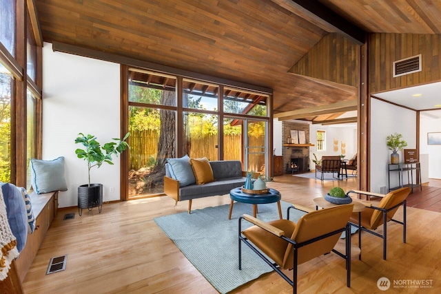 9539 Lake Shore Blvd NE, Seattle, WA 98115 - living area featuring a fireplace, wood ceiling with exposed beams, wood finished floors, and high vaulted ceiling