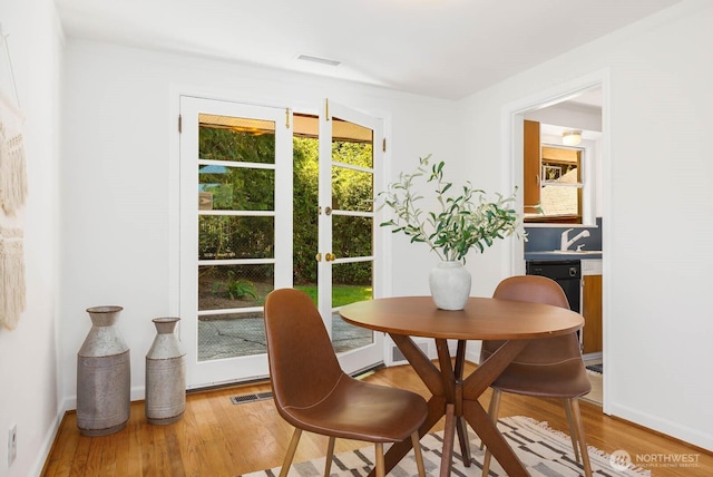 9539 Lake Shore Blvd NE, Seattle, WA 98115 - dining room with wood finished floors, baseboards, and french doors