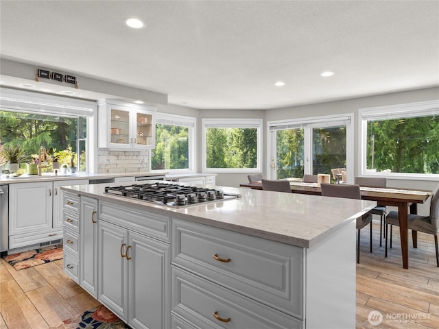 34214 102nd Ave S, Roy, WA 98580 - kitchen with stainless steel gas cooktop, a sink, a center island, light wood-style floors, and recessed lighting