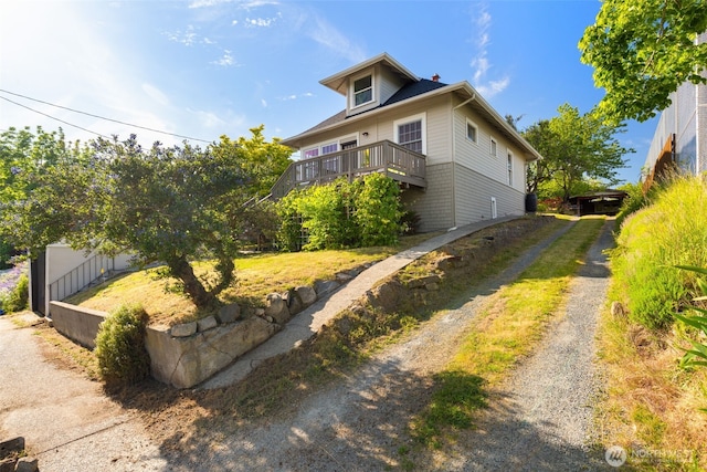 4340S Bennett, Seattle, WA 98118 - view of front facade featuring a deck, brick siding, a chimney, and driveway