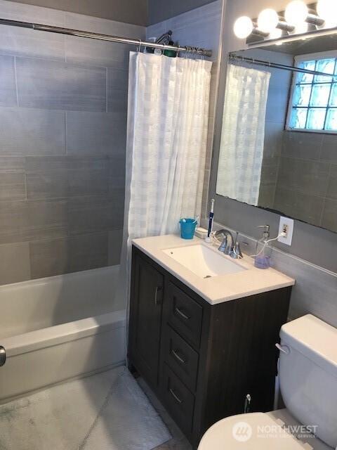 2513 13th Ave W, Seattle, WA 98119 - full bathroom featuring shower / bath combo with shower curtain, vanity, and tile patterned floors