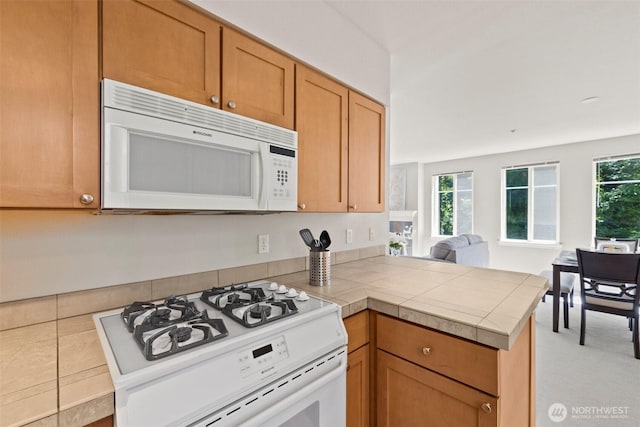 17432 Bothell Way NE Unit B302, Bothell, WA 98011 - kitchen with white appliances, a peninsula, healthy amount of natural light, and open floor plan