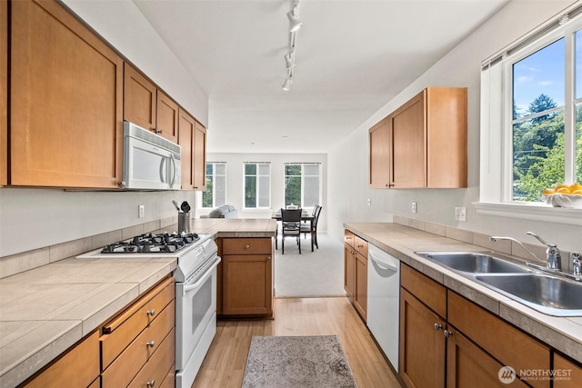 17432 Bothell Way NE Unit B302, Bothell, WA 98011 - kitchen featuring white appliances, light wood finished floors, tile countertops, and healthy amount of natural light